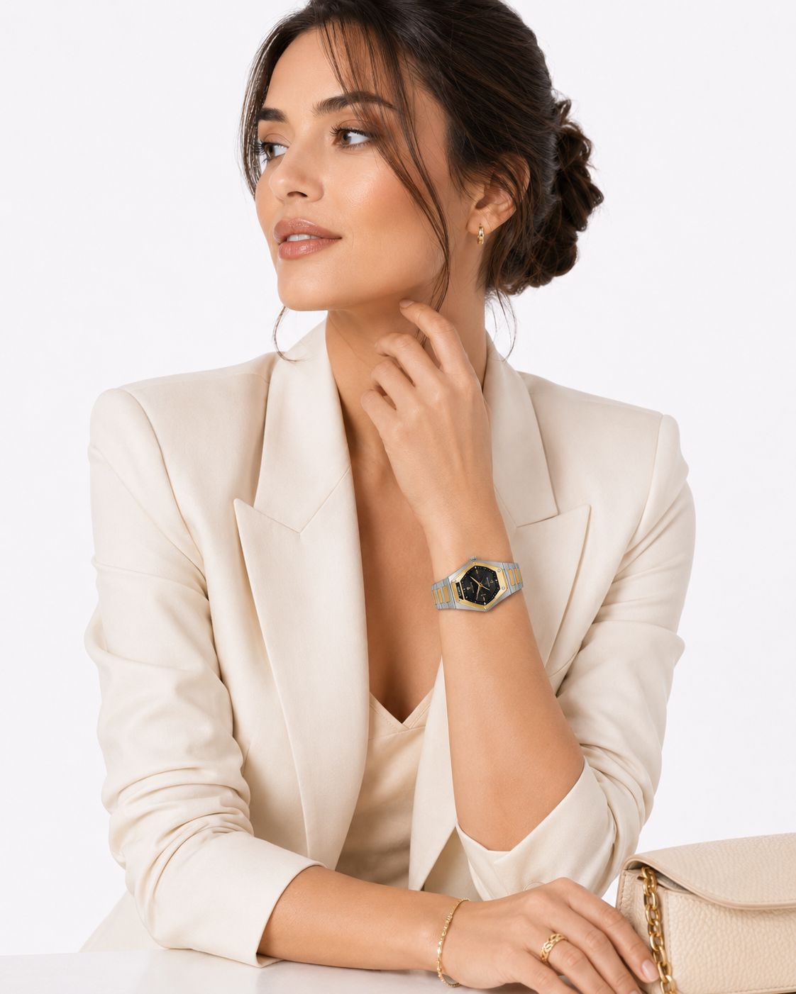 A woman in cream tailoring wearing a ROYALTY© diamond-shaped timepiece